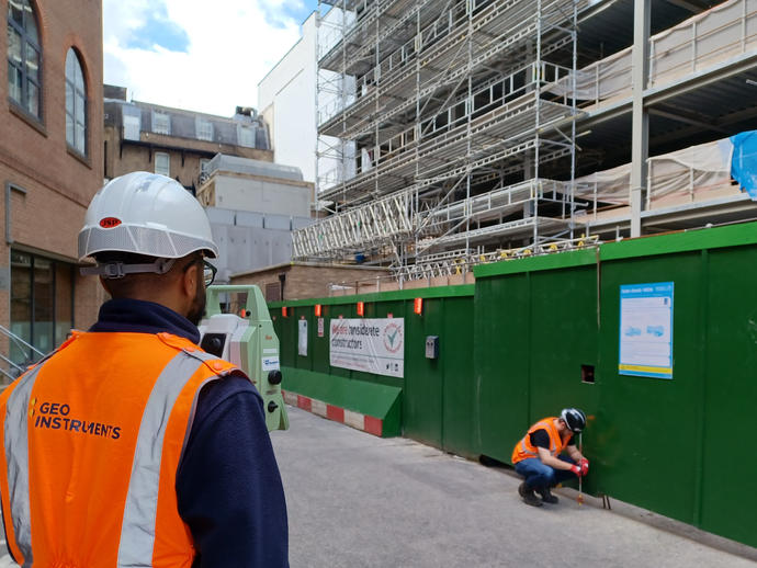 Survey team conducting a 3D prism survey